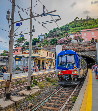 Manarola, Italy - 08 09 2023: Train station in small town with colorful houses on cliff overlooking sea. Train passing all Cinque Terre towns - Riomaggiore, Manarola, Corniglia, Vernaca, Monterosso