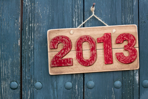 Vintage New Year 2013 date on wooden board background with rope hanging on nail