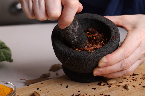 Mortar and Pestle grinding dried chili peppers