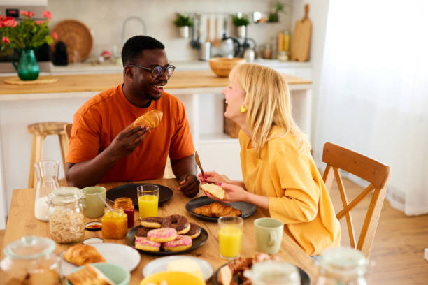 istock Multiracial couple enjoying breakfast together at home 1603335065