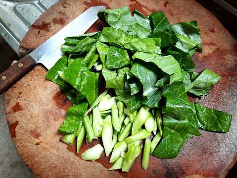 Cutting Chinese Kale vegetable - food preparation.