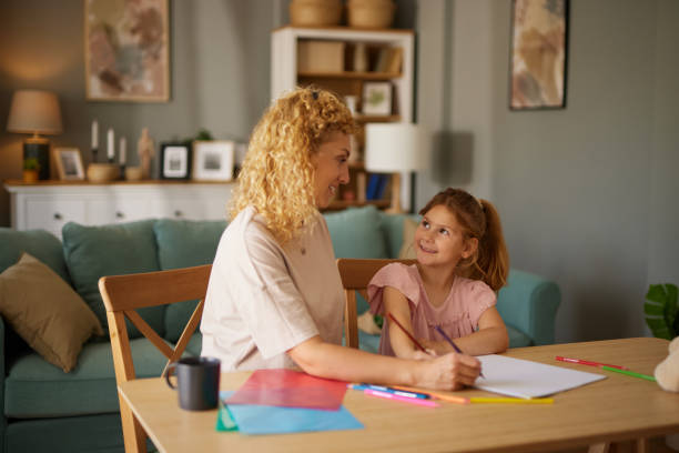 istock Mother and daughter drawing together at home 1603338792