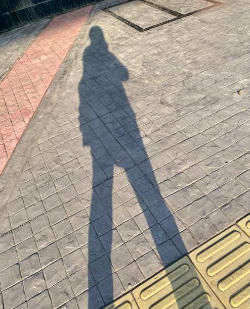 istock Shadow of a woman walking 1603343623