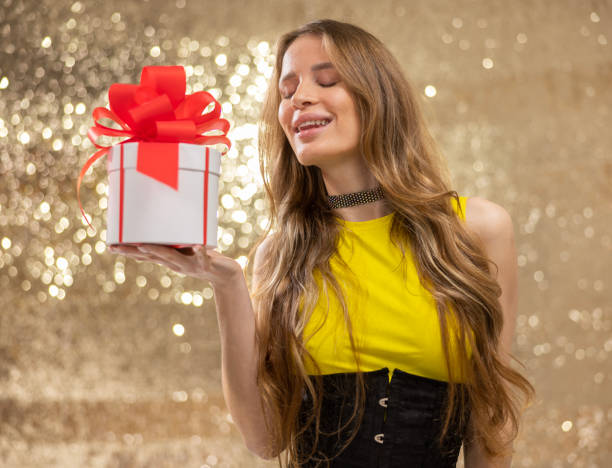 istock woman holding a gift box 1603361618