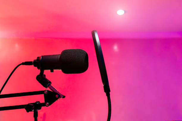 istock Close-up of professional microphone on blue background with studio lighting. 1603362130