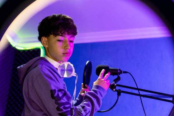 istock Young man recording music with laptop in home studio. 1603365265