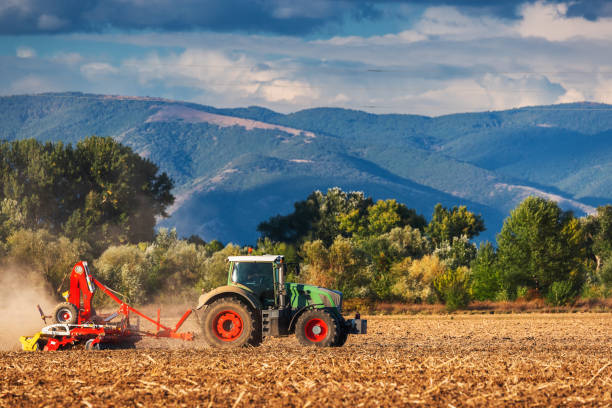istock Farmer in tractor preparing land with seedbed cultivator 1603370653