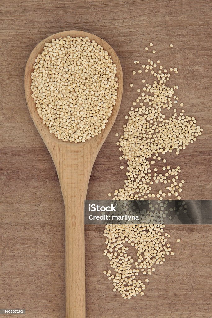 Quinoa Grain Quinoa grain in wooden spoon over papyrus background. Antioxidant Stock Photo