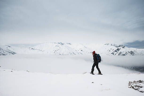 istock Woman Snowshoeing On Mountain Top 160337767
