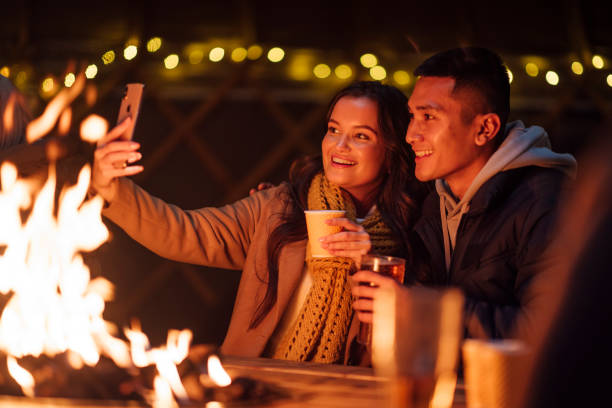 selfie pela firepit - fun knit hat adult dating - fotografias e filmes do acervo