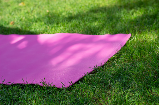Yoga mat on a sunny backyard ready for home morning routine
