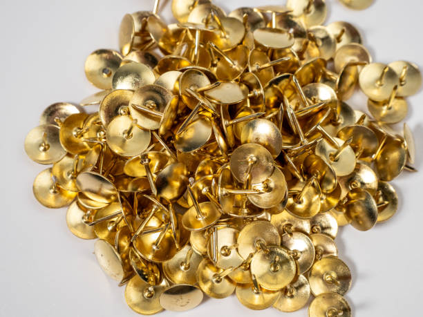 istock Pushpins of gold color on a white background. 1603409016