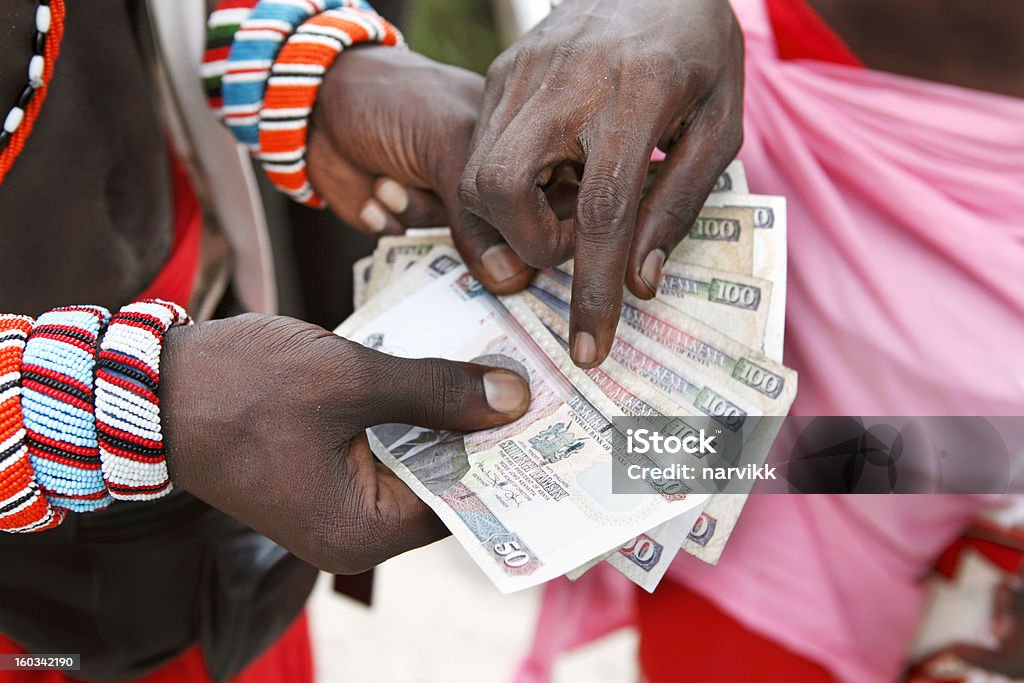 African business Two Masai men counting Kenyan money. See my other photos from Kenya:  http://www.oc-photo.net/FTP/icons/kenya.jpg Kenya Stock Photo