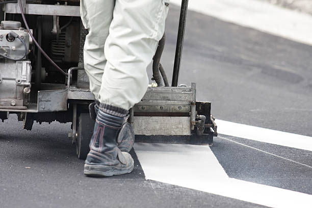 istock Road worker makes a line on new asphalt 160342244