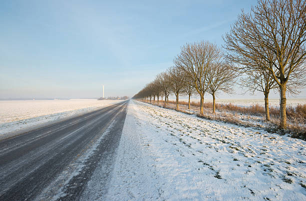 istock Road through a snowy countryside 160343011