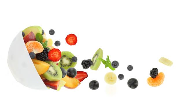 istock Fresh mixed fruits falling into a bowl isolated on white transparent background 1603440289