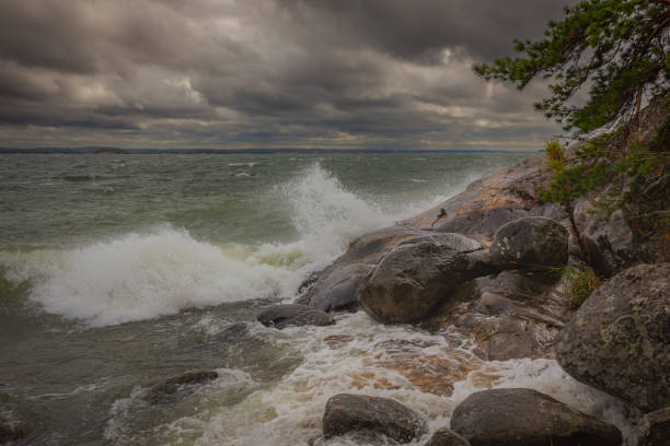 Summer storm and waves hit on the rock