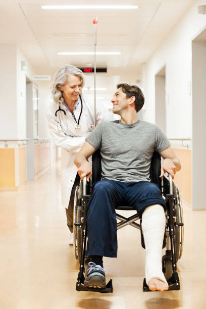 Doctor with recovering patient Doctor with recovering patienthttp://bit.ly/1fTZld6 broken leg stock pictures, royalty-free photos & images