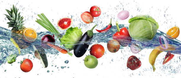 istock Many fruits and vegetables falling into water against white background 1603491951