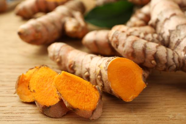 istock Cut turmeric roots on wooden table, closeup 1603493049