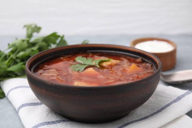 istock Bowl of delicious borscht on table, closeup 1603495332