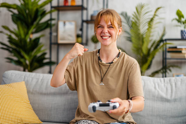 istock Young Woman Playing Video Games At Home 1603497849
