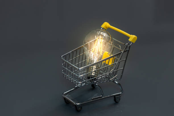 istock Glowing light bulb in shopping cart on dark gray background, Creative light bulb idea, power energy or business idea concept 1603505550