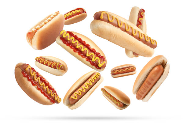istock Many tasty hot dogs falling on white background 1603515140