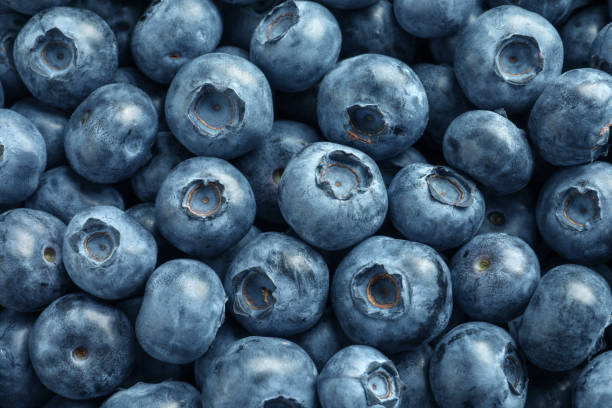 istock Tasty fresh blueberries as background, top view 1603515674