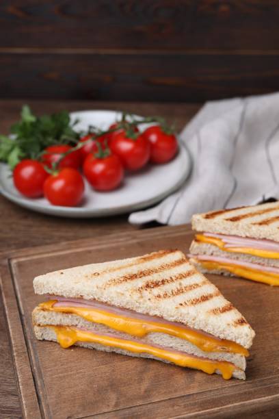 istock Delicious grilled sandwiches with ham and cheese on table, space for text 1603516239