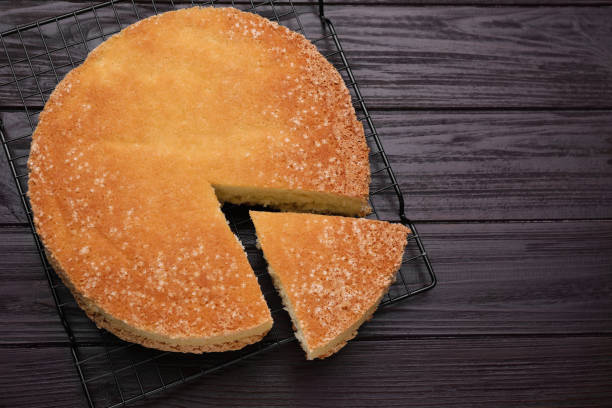 istock Tasty sponge cake on wooden table, top view. Space for text 1603517337