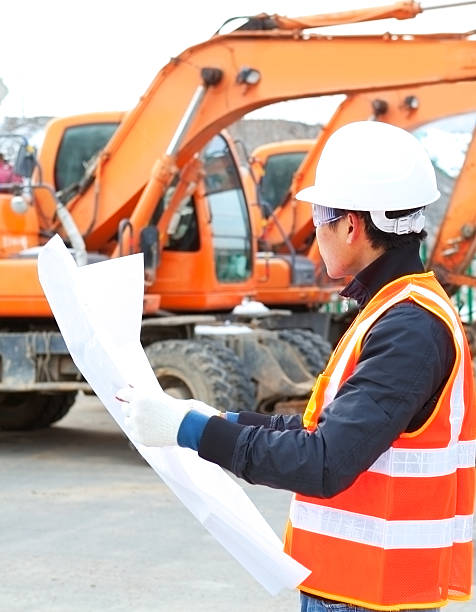istock road construction worker in front of excavator 160353038