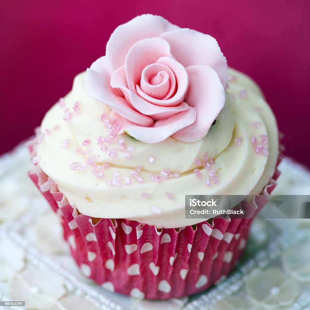 Rose cupcake Cupcake decorated with a pink sugar rose Baked Stock Photo