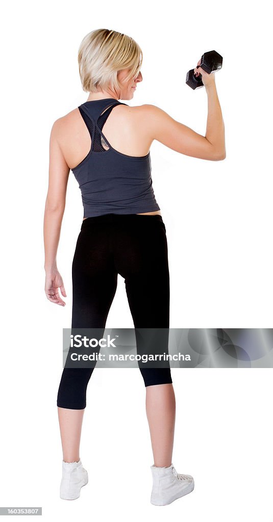 Sollevamento pesi di una donna bionda - Foto stock royalty-free di Abbigliamento sportivo