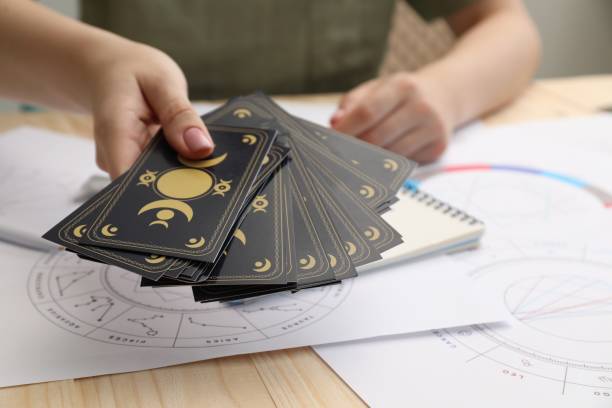 istock Woman using tarot cards at table, closeup. Astrological predictions 1603551196