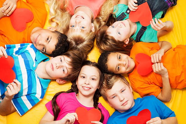 istock Boys and girls in circle with hearts 160355652