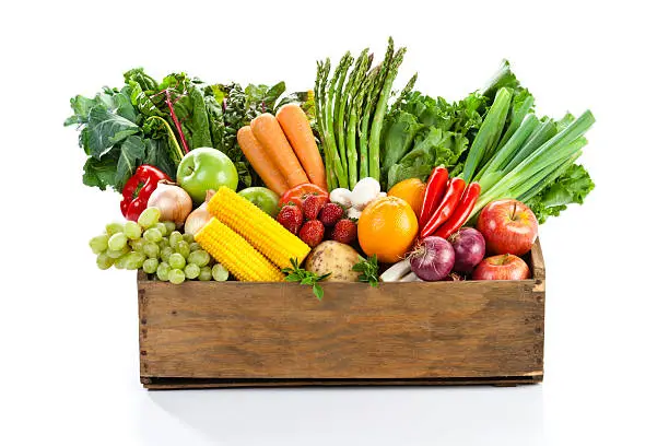Assortment of Fruits and Vegetables Inside Wood Box Isolated on White Background. Front View.
