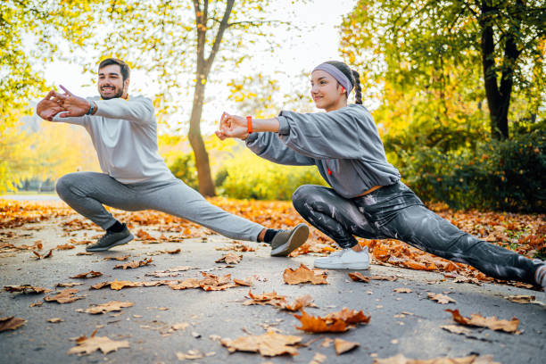 istock Young couple exercising together in the park 1603580207