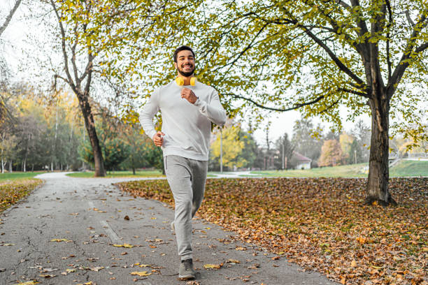 istock Sporty man running in the park 1603583354
