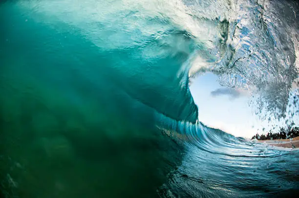 A barreling wave draws the sand off a shallow sandbar on the North Shore of Oahu