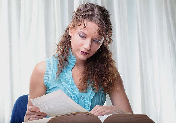 istock Young woman with book on white background. 160359419