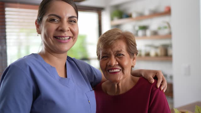 Portrait of home caregiver with senior patient at a nursing home