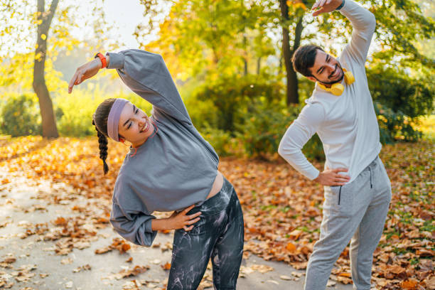 istock Young couple stretching together outdoor 1603606451