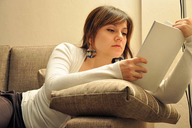istock Cute young woman reading a book 160360955