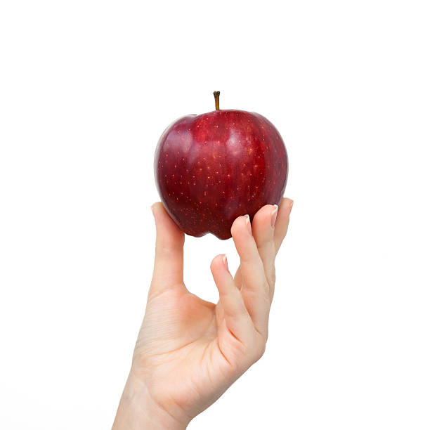 woman hand on isolated background holding a red apple stock photo