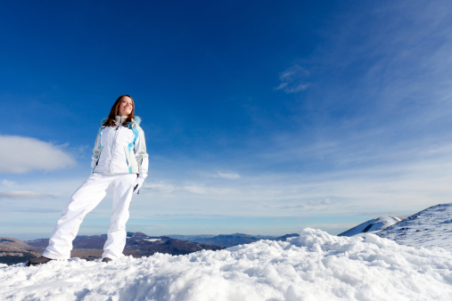 Beautiful young woman on snowy mountain