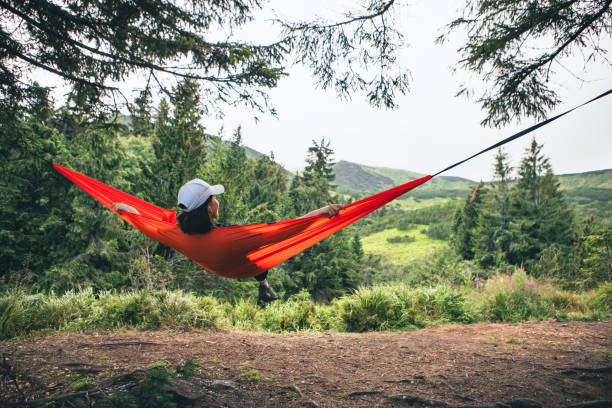 istock happy woman on hammock mountains on background 1603637289