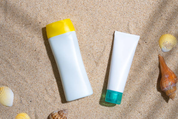 istock Sunscreen container mockup with sea shells and palm leaves shadow 1603660729