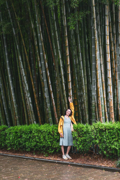 istock woman is posing against large bamboo forest 1603664560