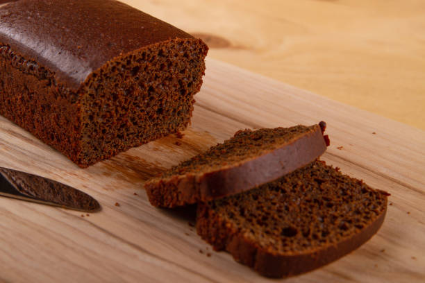 istock Black bread on wooden background 1603665150